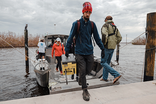 Image of people unloading an SCCF boat
