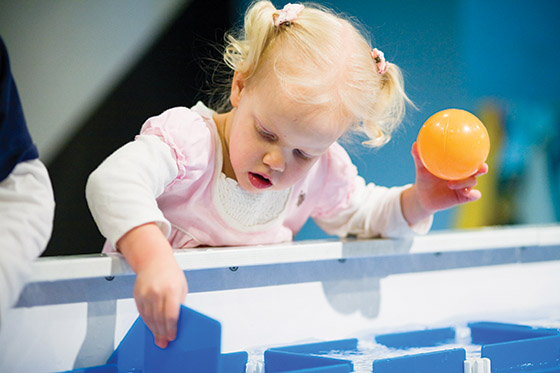 A young child plays at the water table at Great Lakes Children Museum in Traverse City