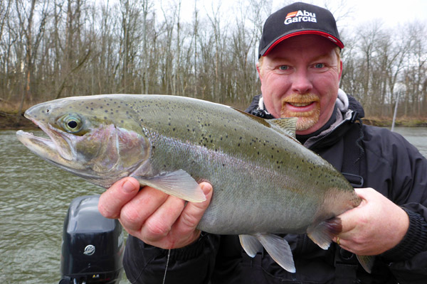 Miles Hanley shows off a nice steelhead he hooked while fishing the Kalamazoo River downstream from the Allegan Dam. Photo by Howard Meyerson