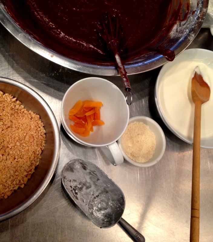 Doughnut ingredients including chocolate ganache, peanuts, and dried apricot.