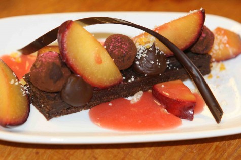 Amway Grand Plaza's Flourless chocolate cake with fresh plums and plum and champagne sauce