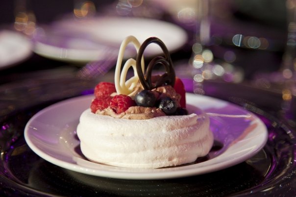 Meringue shell filled with mousse and garnished with delicate bush berries Meringue shell filled with mousse and garnished with delicate bush berries