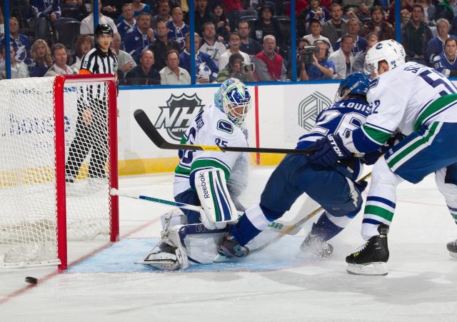 Cory Schneider #35 of the Vancouver Canucks makes a save against Martin St. Louis #26 of the Tampa Bay Lightning as Alexander Sulzer #52 defends during the first period at the Tampa Bay Times Forum on January 10, 2012 in Tampa, Florida. (Photo by Scott Audette/NHLI via Getty Images) Cory Schneider #35 of the Vancouver Canucks makes a save against Martin St. Louis #26 of the Tampa Bay Lightning as Alexander Sulzer #52 defends during the first period at the Tampa Bay Times Forum on January 10, 2012 in Tampa, Florida. (Photo by Scott Audette/NHLI via Getty Images)