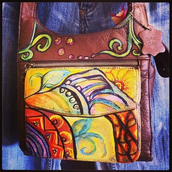 A local artist makes old new again with these hand-painted purses at Jane's on the Square. Hand-painted purse from Jane's on the Square in Danville, Indiana