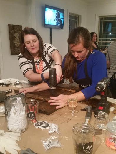 Two friends help each other on their individual projects. Friends helping each other at Board and Brush