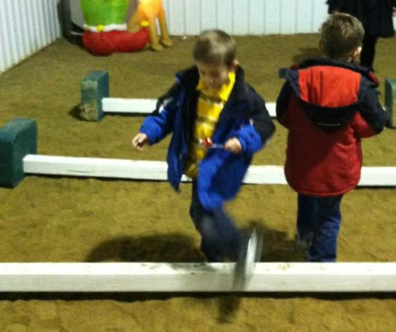 Kids enjoying 'reindeer games' at last year's event. kids jumping over beams