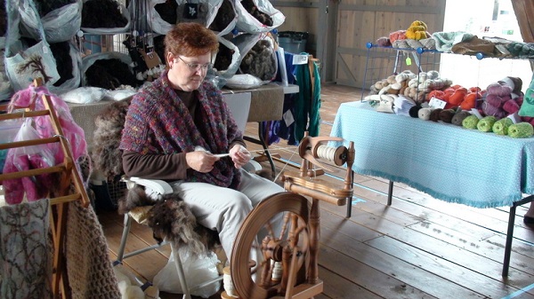 This woman is using a spinning wheel.