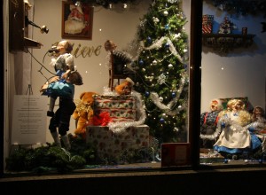 Elves decorate the Christmas tree and answer the telephone in one of the windows at the Embassy Theater and Indiana Hotel Lobby.