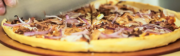 Hideaway Pizza Being Sliced