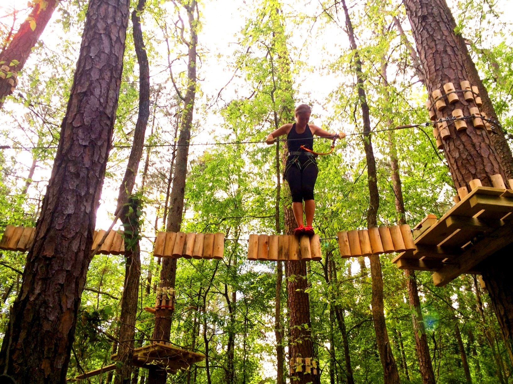 Girl on logs at treetop quest