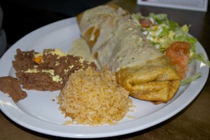 J's Chimichanga, covered with jalapeno cheese sauce and served with refried pinto beans and rice.