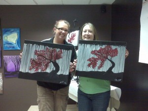 My wife (right) and her friend showing off their paintings.