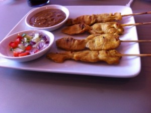 chicken satay with a sweet and sour sauce and peanut sauce