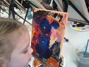 My daughter, 4 years old at the time, working on her Cookies & Canvas painting.
