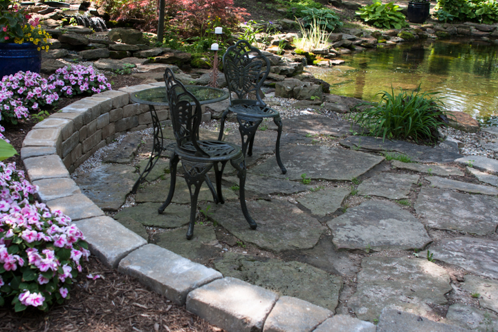 Reminiscent of a French patio, tables, chairs, and benches like these are placed throughout the grounds and welcome you to take a seat and relax.