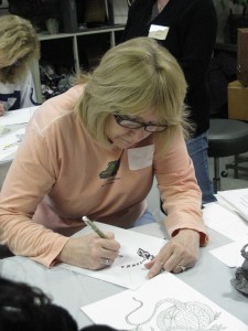 Billie Barton of Clermont works on a piece during the Zentangle class at Finer Things.