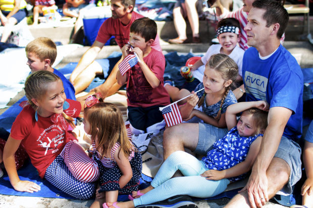 Family sitting in the shade watching parade