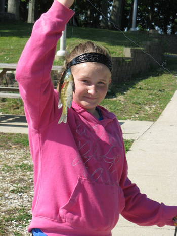 A participant in the 2012 Kids’ Fishing Derby, part of Free Fishing Weekend, shows off her catch. Photo Credit: Dave Kittaka A participant in the 2012 Kids’ Fishing Derby, part of Free Fishing Weekend, shows off her catch. Photo Credit: Dave Kittaka