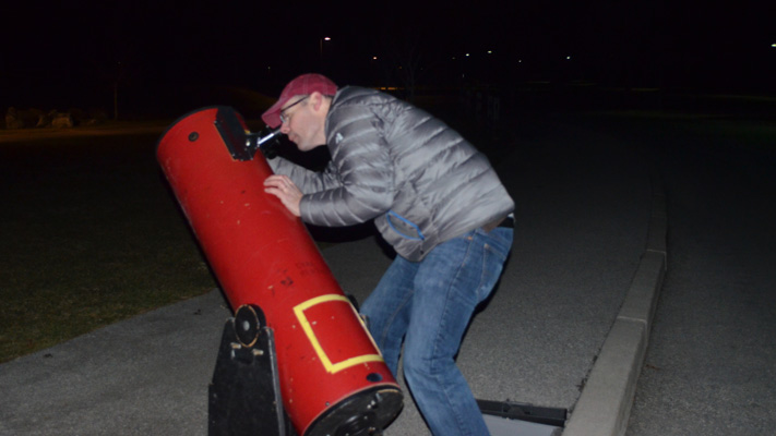 Rob Becker gazes into his telescope. Rob Becker gazes into his telescope.