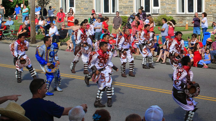 The Caporales San Simon adds international flair to the July 4 festivities.