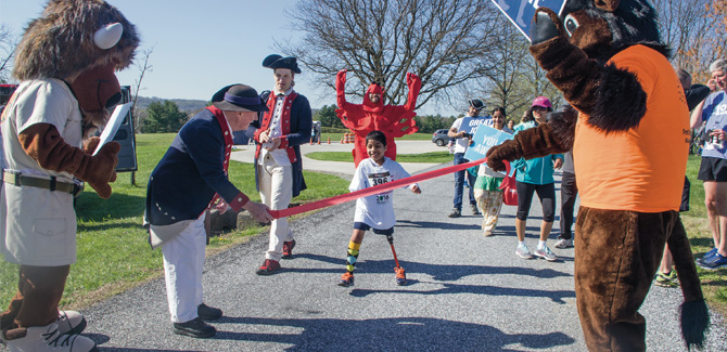 Hari had gained quite the cheering section by the time he crossed the finish line. Hari had gained quite the cheering section by the time he crossed the finish line.