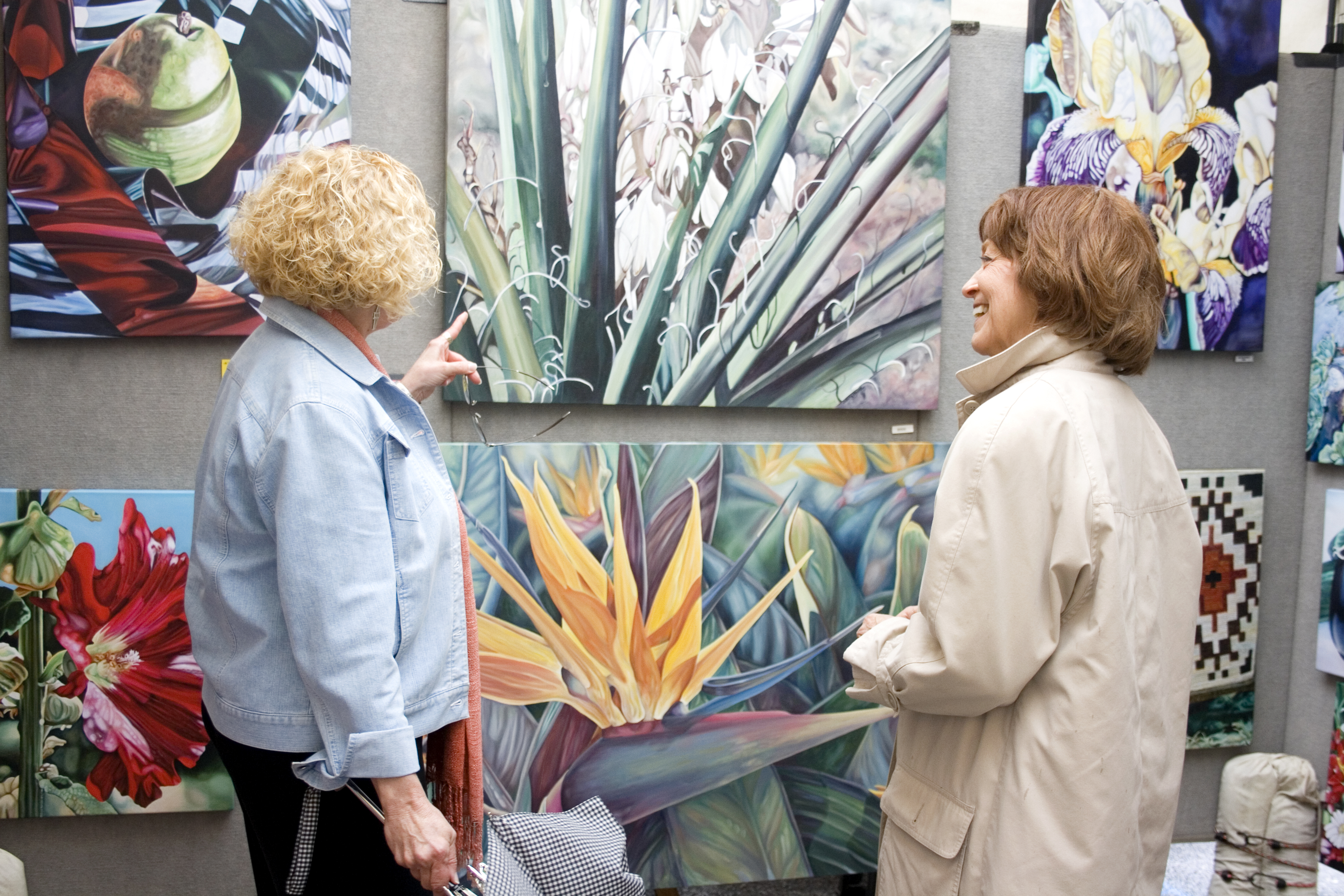 Two women looking at a painting at the Stillwater Arts Festival