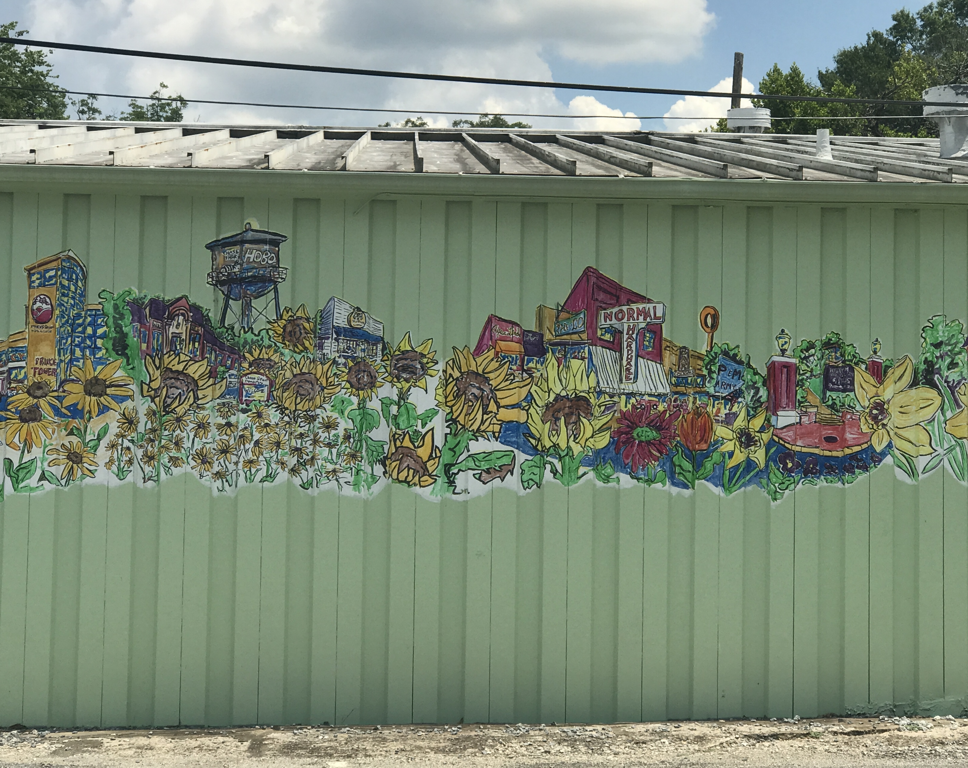 A mural of Athens with flowers on the side of Flowerland.