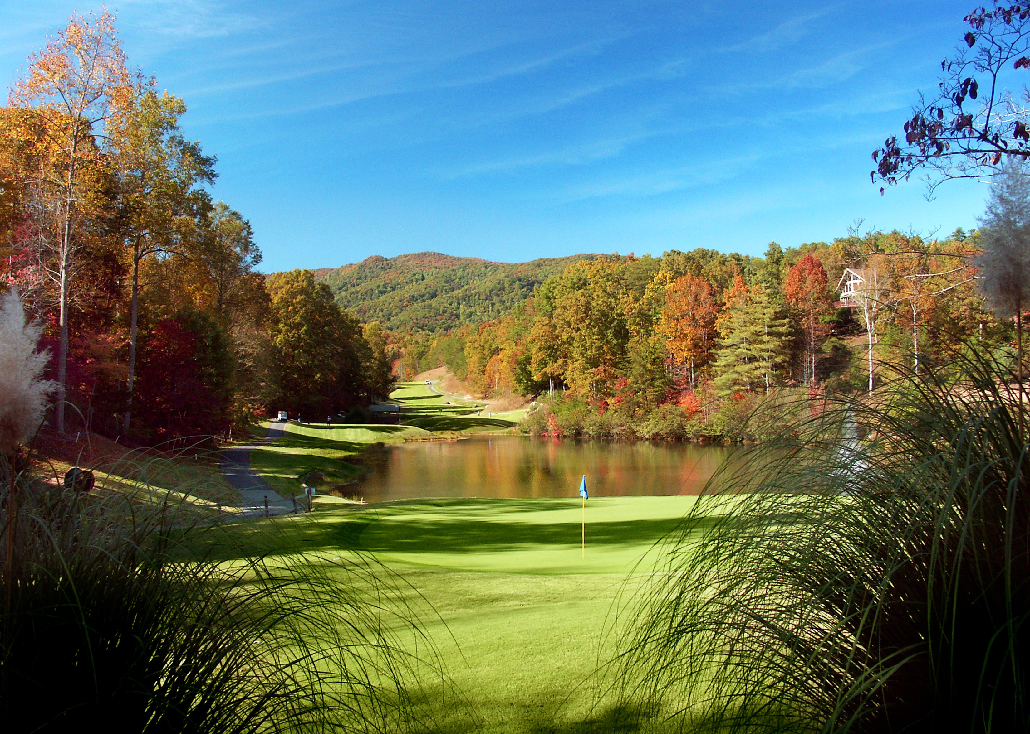 Fall color backdrop at Rumbling Bald Golf Course