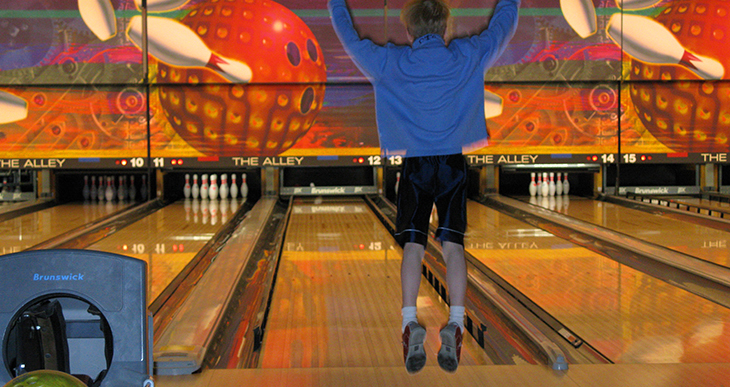 Celebrating after a strike at The Alley Bowling