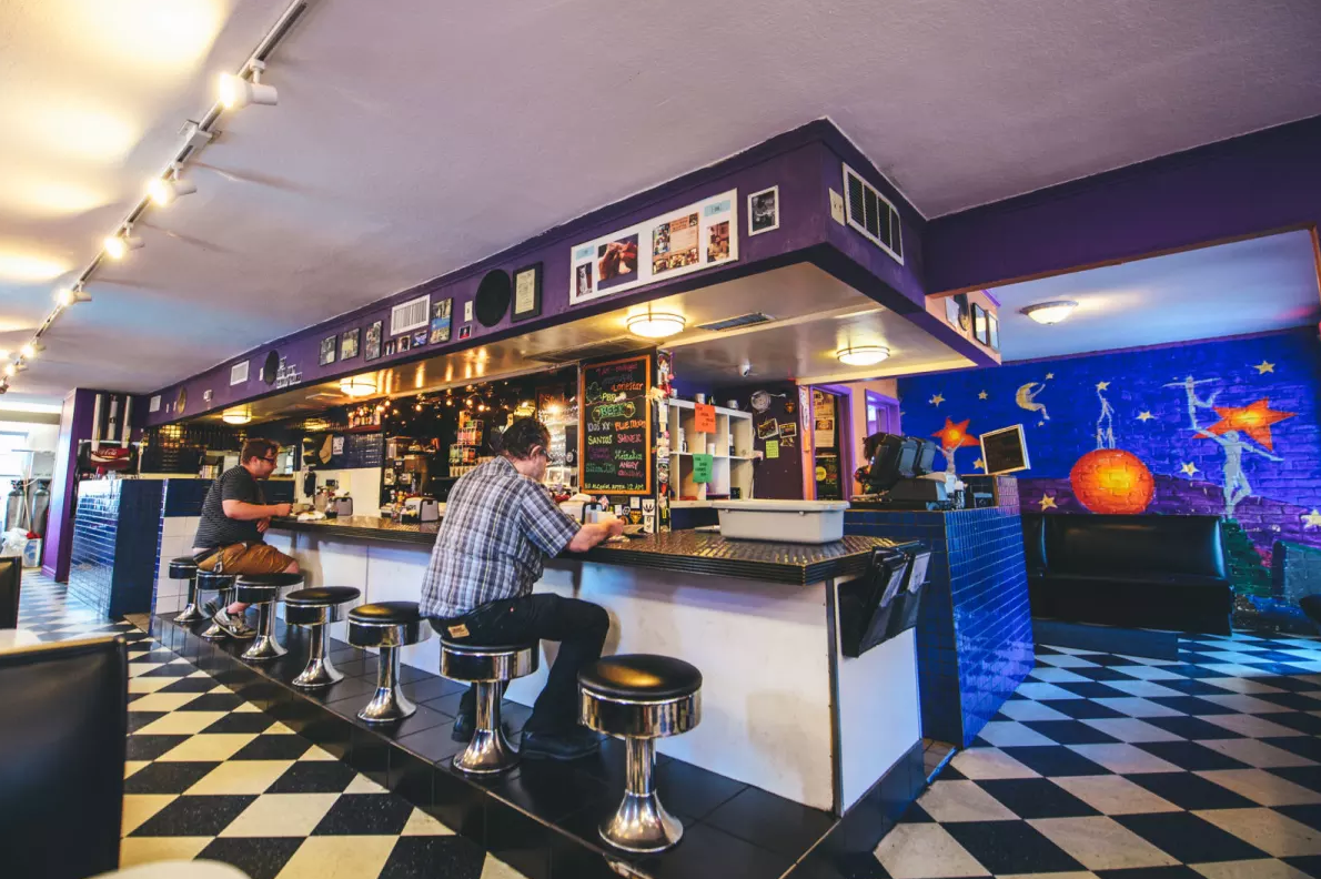 Star Seeds diner with man sitting at counter