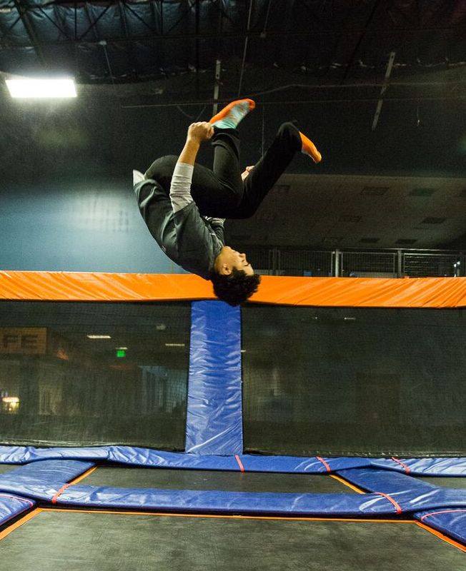 Boy doing backflip on a trampoline at Sky Zone in Lafayette