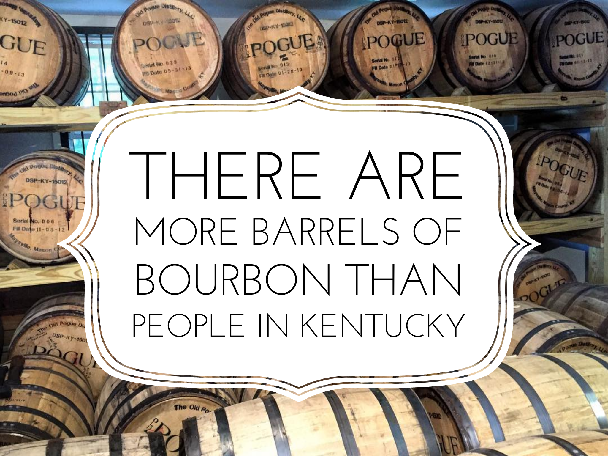 Bourbon barrels with a white sign that reads there are more barrels of bourbon than people in Kentucky.