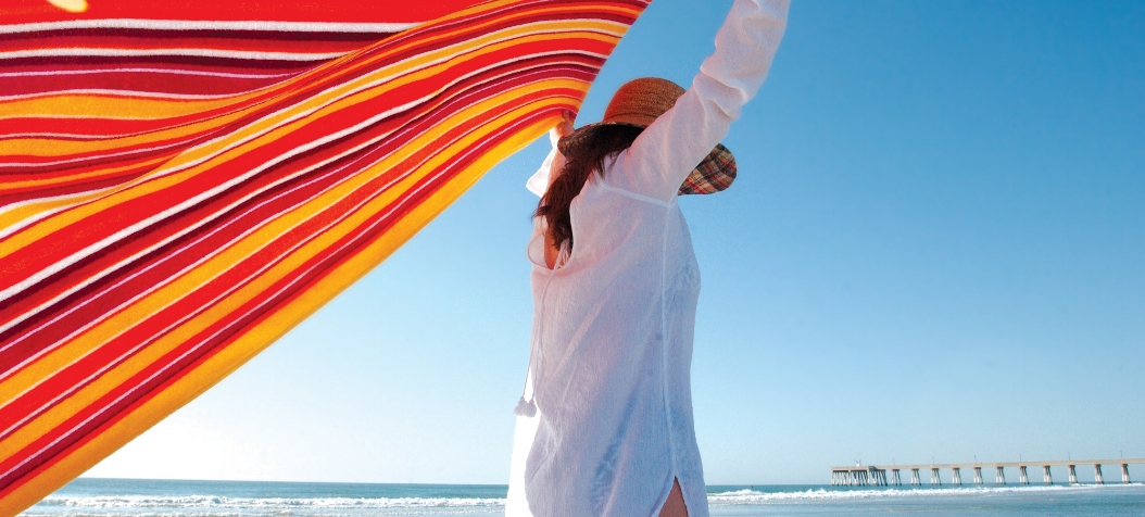 Woman on Wrightsville Beach with a colorful towel