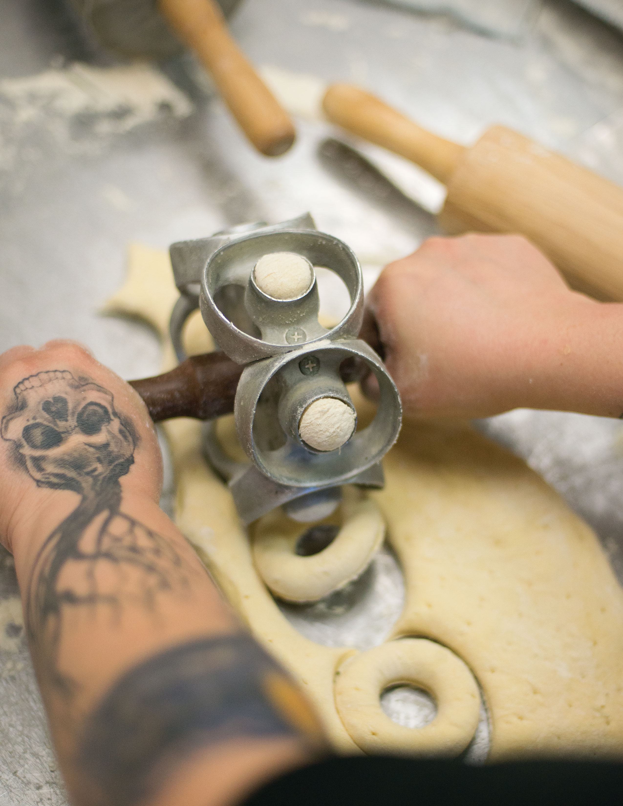 Punching through dough at Rebel Doughnuts