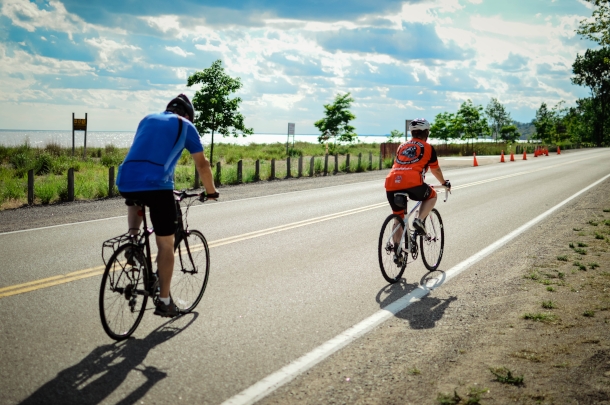 couple cycling on waterfront trail