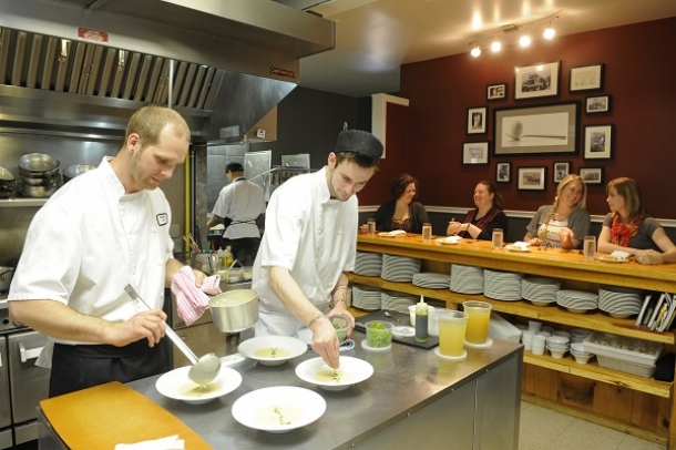 Chefs cooking with customers looking