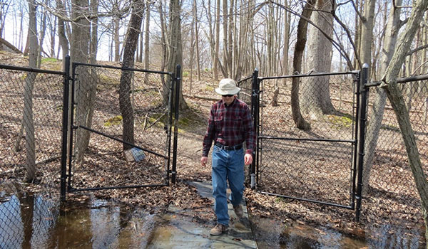 Guy Walking Out of Michael Nichols Pinhook Bog gate