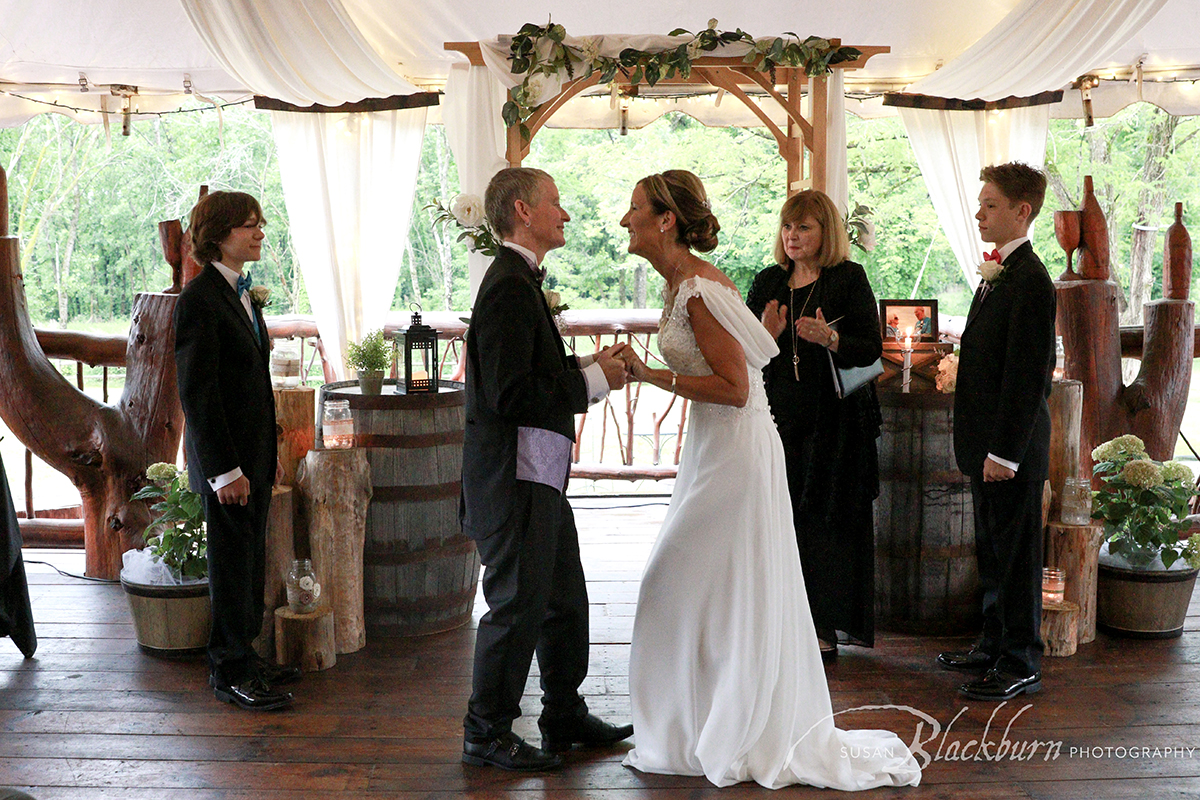 Couple smiling and holding hands during wedding ceremony at Saratoga Winery