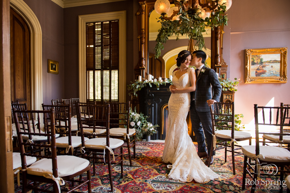 Couple on their wedding day posing inside the Mansion Inn