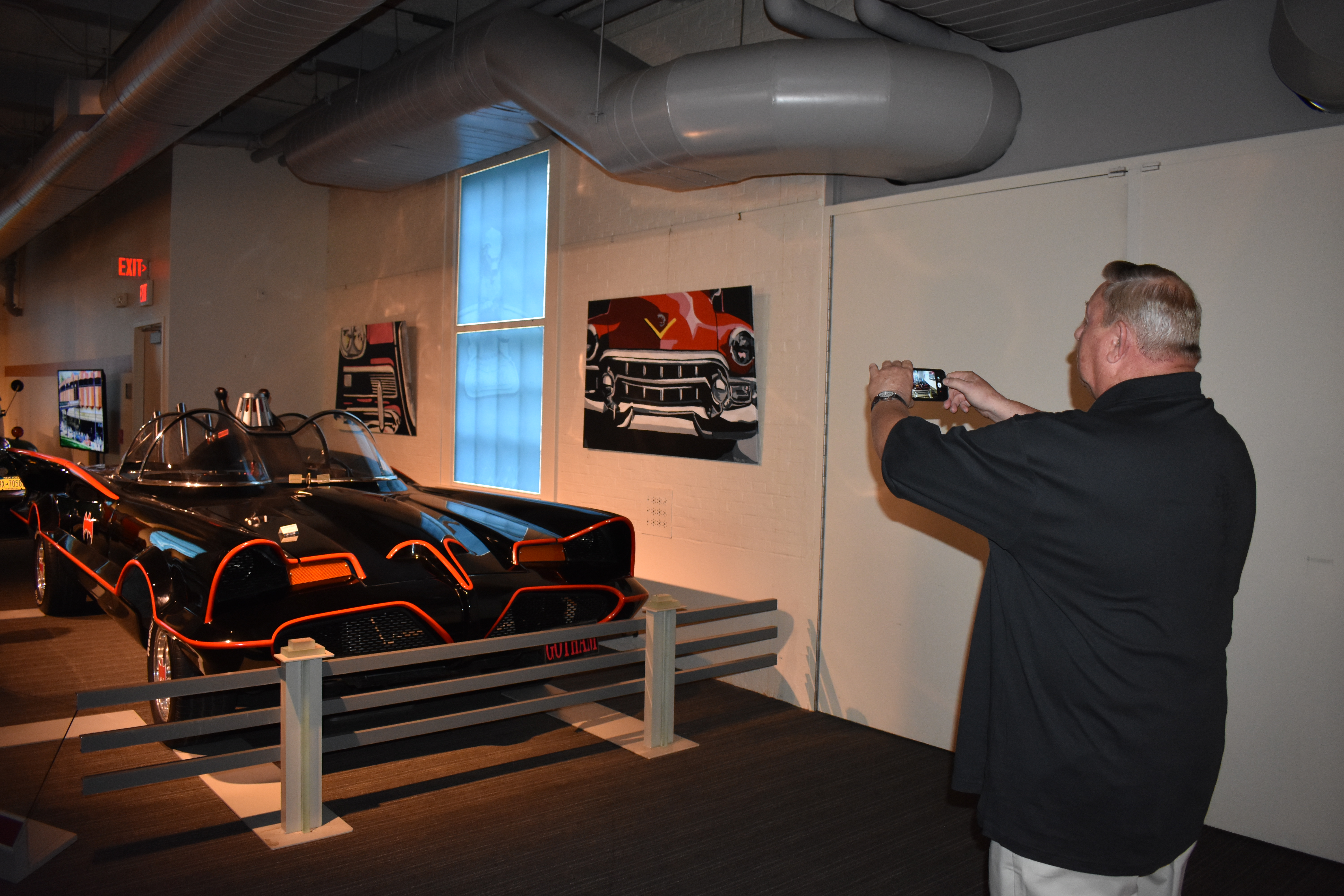 Man taking photo of 1966 Batmobile Replica at Saratoga Automobile Museum