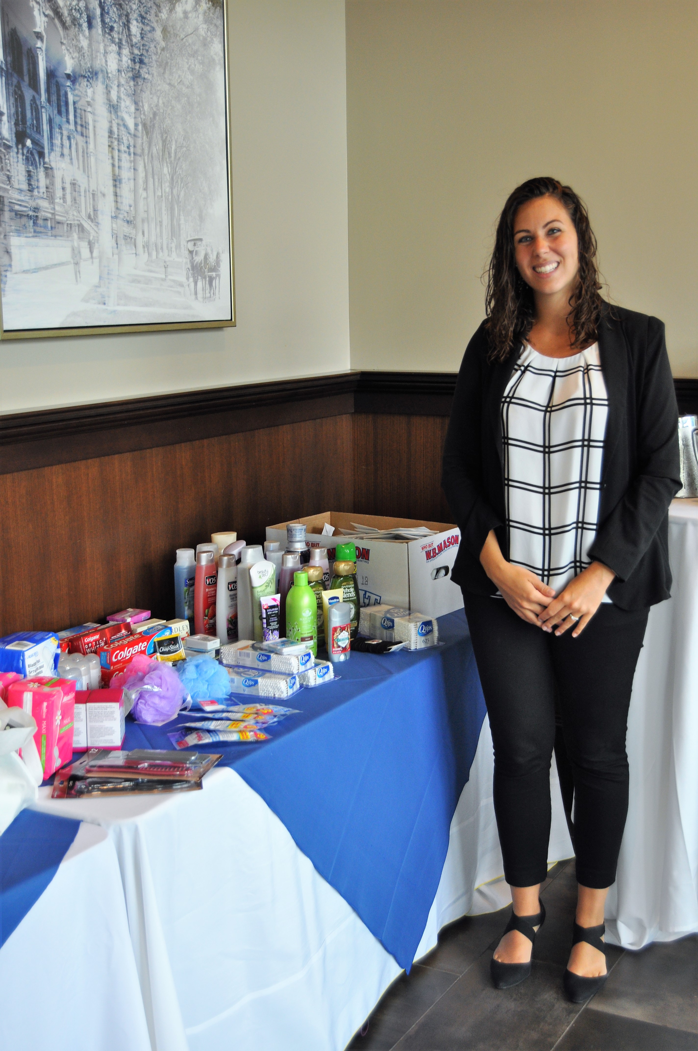 Stevie Church standing by donations table with hands crossed