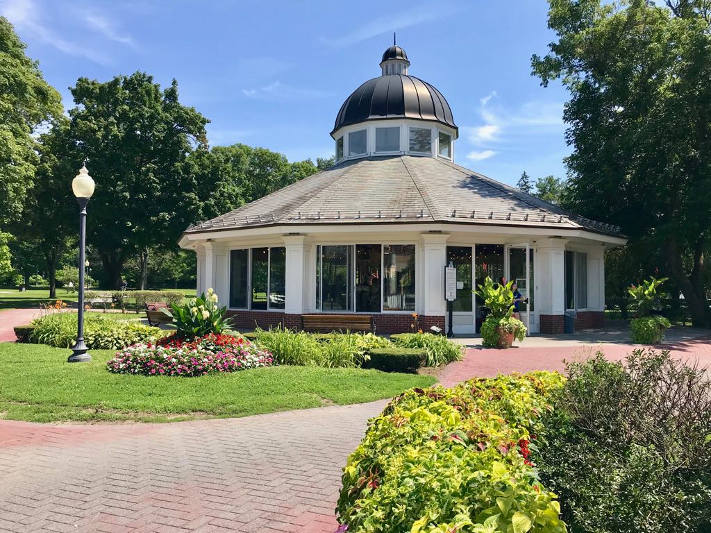 Carousel in Congress Park with plants in front of it