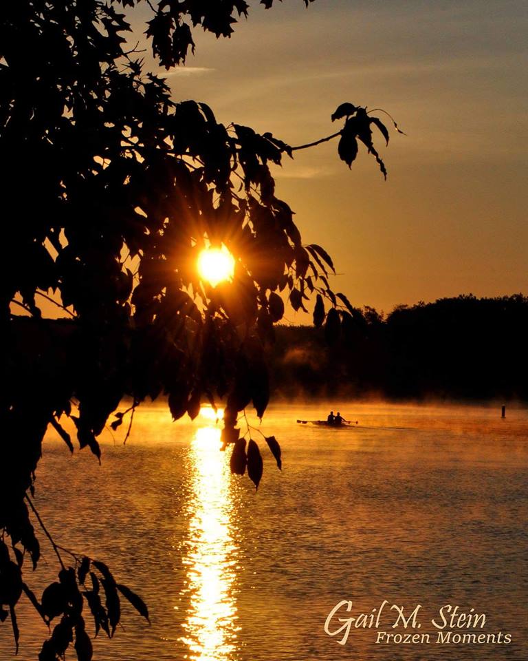 Saratoga Lake at sunset with a kayaker in silhouette.