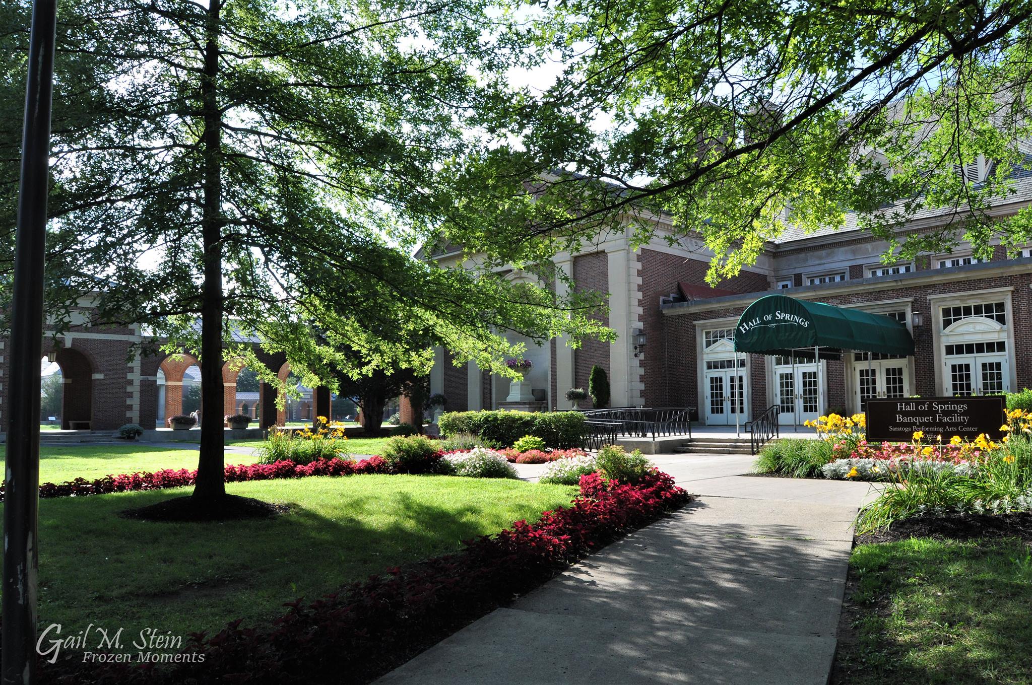 The Hall of Springs surrounded by trees and flowers