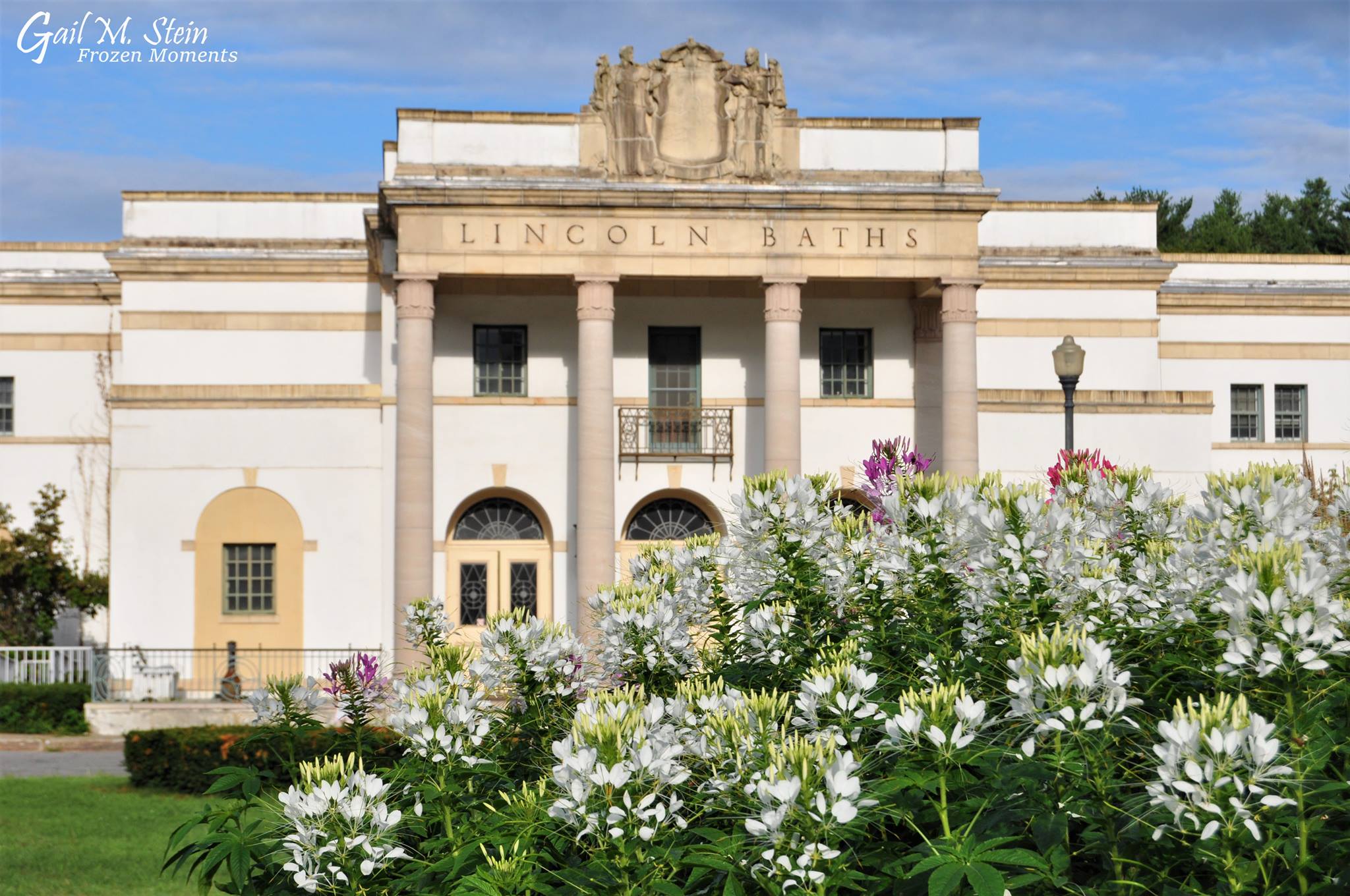 The Lincoln Baths with white flowers in front of it.