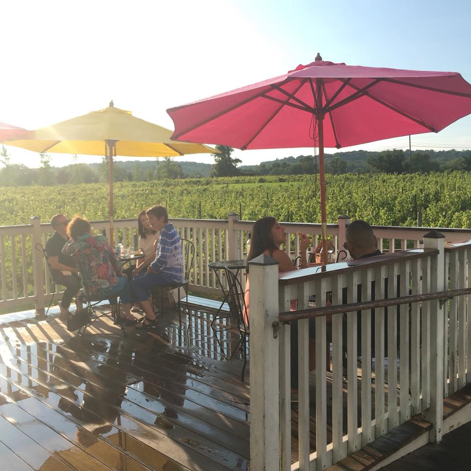 Wine tasters under umbrellas at the Hopewell Valley Vineyards in NJ