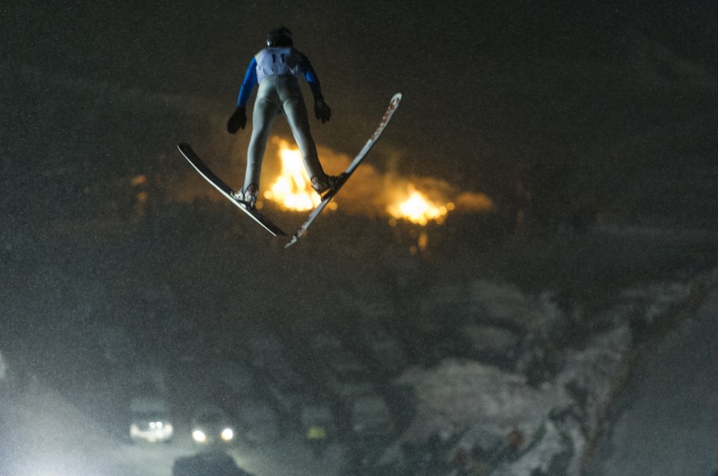 Ski jumping at night during a tournament at Suicide Bowl ski jumping area in Ishpeming, Michigan.