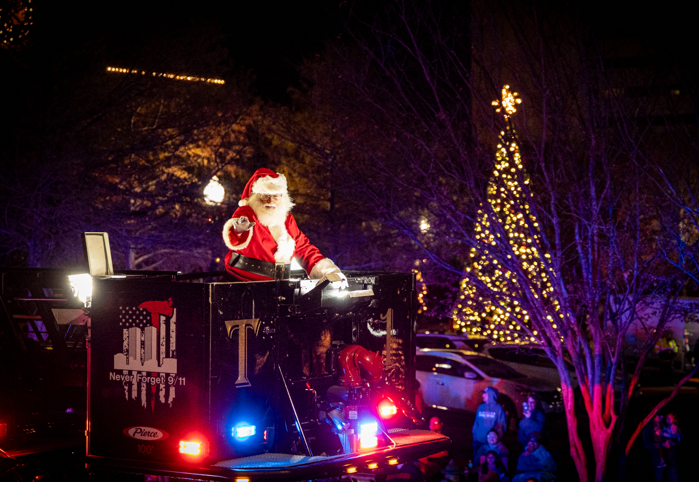 Santa on float with Christmas Tree in background