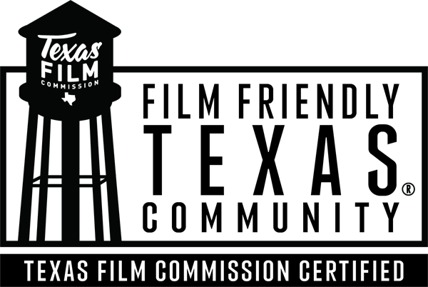 Black and white logo featuring a classic Texas water tower with the words “Texas Film Commission” and a small Texas outline, followed by bold text reading “Film Friendly Texas.”