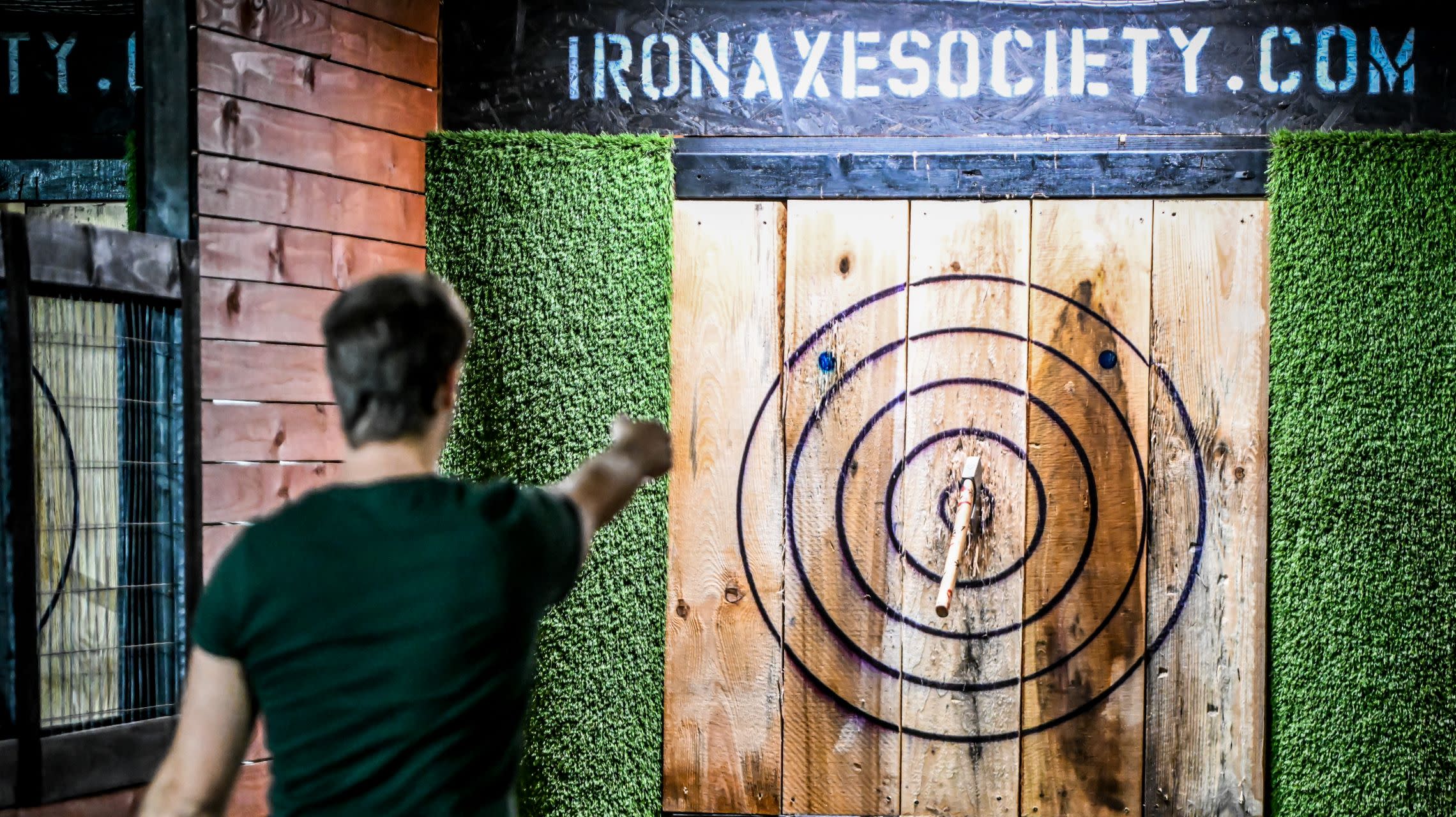 man throwing axe at target